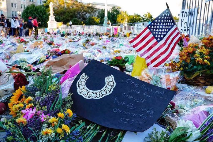 shutterstock_1818977057 Memorial site with flowers and a U.S. flag