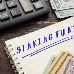 Taylor Farms Shock: Fake Vendors, Real Cash Notebook labeled sinking fund beside cash, calculator, and pen