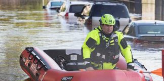 Rescue worker in an inflatable boat during urban flooding
