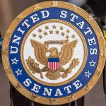 Surprise GOP Rebels Trip Trump’s Voter ID Push United States Senate seal at a podium
