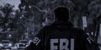 Cartel Horror: FBI Mole’s Bone-Chilling Claim FBI agent in jacket facing a city street at dusk