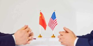 War With China? Rubio’s Stark Warning Two diplomats sit across table with China and United States flags between them