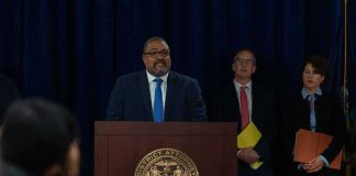 Man at podium during press conference