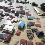 Glacier Break Triggers Deadly Wave Aerial view of flooded residential neighborhood