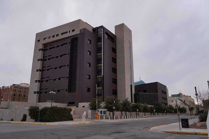 shutterstock_2253767651 Modern concrete and dark glass government building on a cloudy day