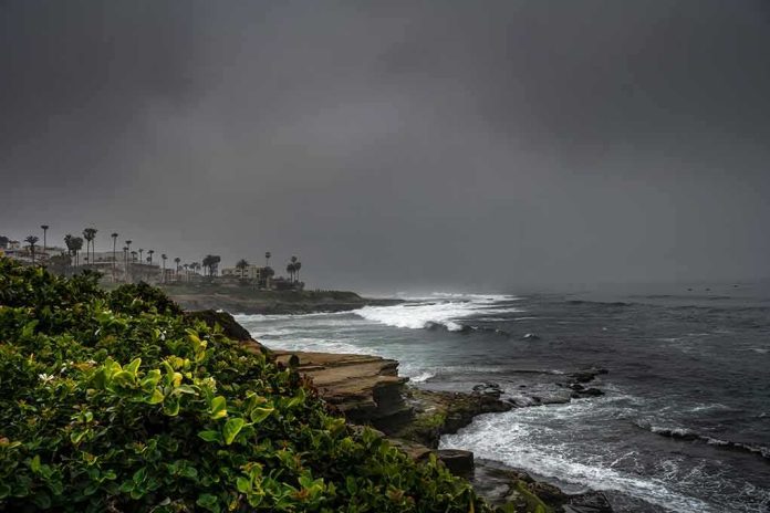 shutterstock_2274329619 Rocky coastline with waves under dark storm clouds
