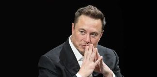 man in a suit with hands clasped thoughtfully
