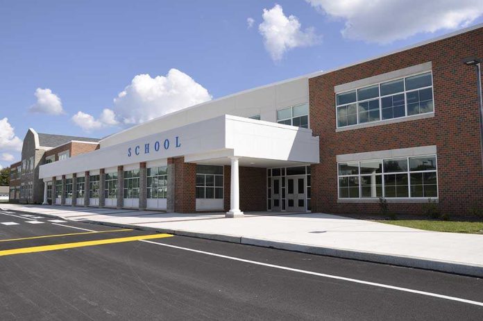 Modern school building with large windows and a clear sky