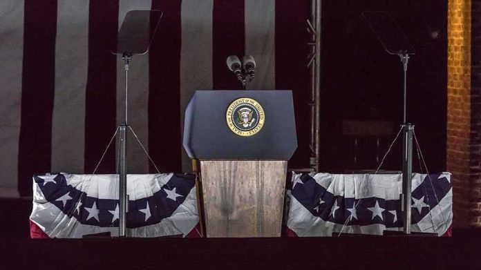shutterstock_636136928 Presidential podium with microphones and teleprompters