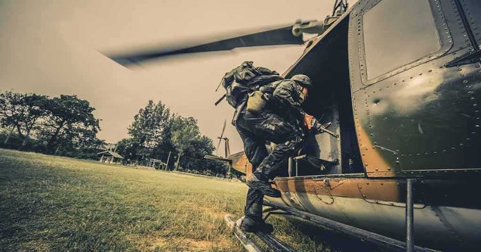 shutterstock_643981108 Soldier boarding a helicopter during field operation