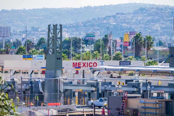 shutterstock_688819600 Border crossing booths at Mexico entry point with cityscape in background