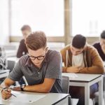 Shocking Claim: Reteaching Middle School Math Students taking a written exam in a classroom