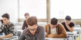 Students taking a written exam in a classroom