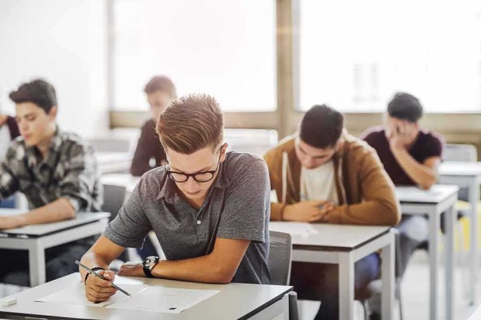shutterstock_704245198 Students taking a written exam in a classroom
