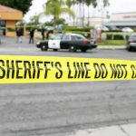 Active Shooter Terror At In-N-Out yellow sheriff's line tape blocks a street near police cars