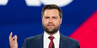 Man in suit speaking at a podium