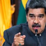 Power Clash: DOJ vs. ‘President’ Maduro Man speaking passionately and gesturing during a speech.