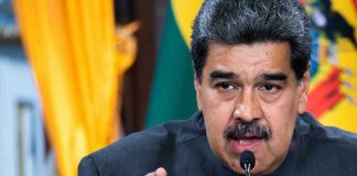 Power Clash: DOJ vs. ‘President’ Maduro Man speaking passionately and gesturing during a speech.