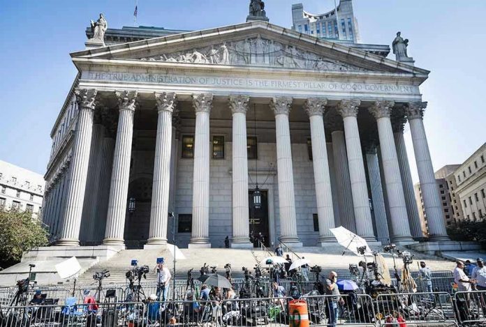 Reporters and photographers gathered outside a neoclassical courthouse