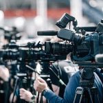 High-Rise Carnage Sparks City Panic Broadcast cameras on tripods at a press event