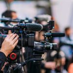 Trademark Showdown: Demon Hunter vs. Netflix Video cameras on tripods at a media event