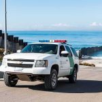 Deputies Swarm Kamala Harris’ Malibu Grounds Border patrol SUV parked near beach fence