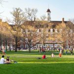 China-Linked Funds Spark Campus Reckoning Students relaxing on a campus quad in front of a brick academic building