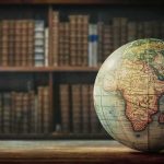AI Map Sparks Global Freak-Out Vintage globe on wooden table in front of blurred bookshelf