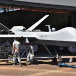CUBA’S Drone Showdown: Are WAR Clouds Looming? Military drone being serviced by ground crew outside a hangar