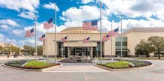 Ground Zero Reunion Sparks Questions American flags at half-staff around a library entrance