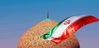 Two-Week Meltdown Warning Rattles Tehran Iranian flag waves before an ornate mosque dome at sunset