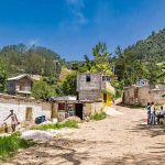 47 Murdered in Church Rural village street with people gathered and hills in the background
