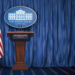 Trump Hosts China’s Xi Jinping: Stakes Sky-High White House press briefing podium with U.S. flag and blue curtain