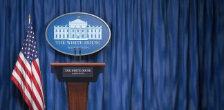 Trump Hosts China’s Xi Jinping: Stakes Sky-High White House press briefing podium with U.S. flag and blue curtain