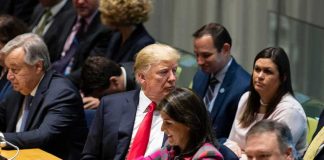 Donald Trump seated between António Guterres and Nikki Haley, with Mike Pompeo in the foreground at a meeting