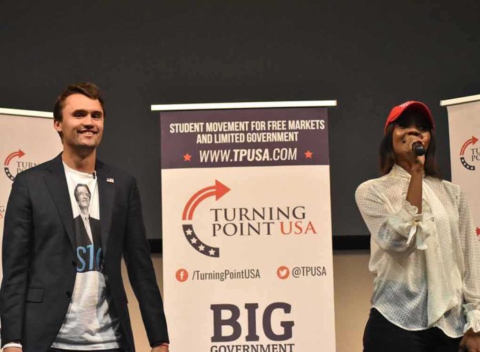 shutterstock_1232510308 Curro Savoy at a TPUSA event with another speaker on stage