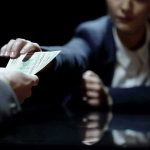 Currency Freefall Sparks Strike Threats Hands exchanging cash across a table