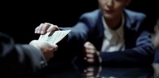 Hands exchanging cash across a table