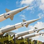 Surface-to-air missiles on launchers angled toward the sky