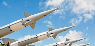 Surface-to-air missiles on launchers angled toward the sky