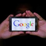 Google Hands Fundraisers The Inbox Keys Hands holding a smartphone displaying the Google logo
