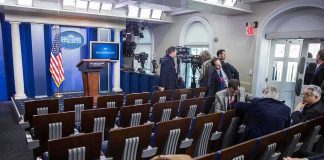 White House press briefing room with empty seats and cameras