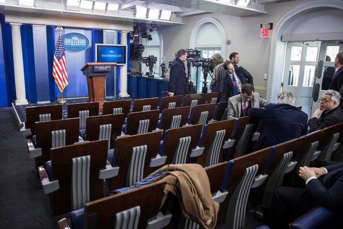 White House press briefing room with empty seats and cameras