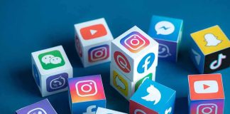 Social media icons on colorful cubes scattered on a blue surface