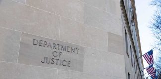 Department of Justice building exterior with American flags