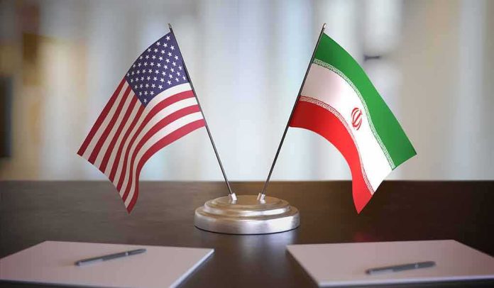 United States and Iran desk flags on a stand