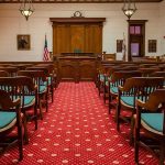 Jury Shocks: Teen Self-Defense Denied Courtroom with wooden benches facing the judge's bench