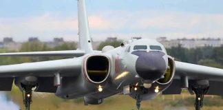 Military jet bomber landing on runway