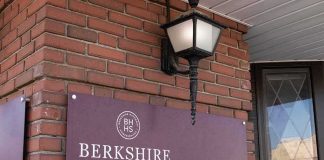 Berkshire Hathaway HomeServices Realtors sign on brick wall