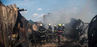 Congress Finally Admits Pentagon Poisoning Firefighters amid twisted metal and smoke at a disaster site